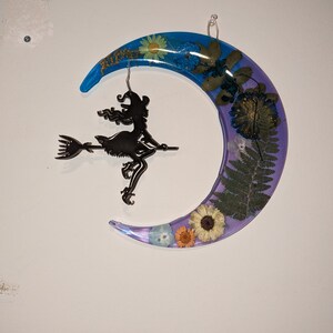 crescent moon with witch hanging