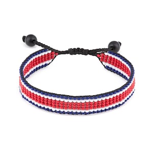 May include: A red, white and blue beaded bracelet with a black cord and black bead closures.