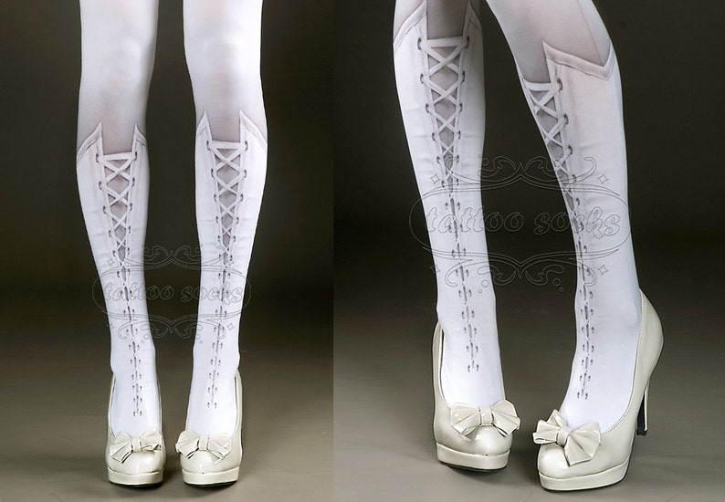 May include: White tights with a lace-up boot design printed on the legs. The tights are worn with white high-heeled shoes with a bow detail.