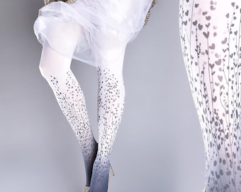 May include: White tights with a gradient ombre design in shades of grey. The tights feature a repeating pattern of small hearts on stems.