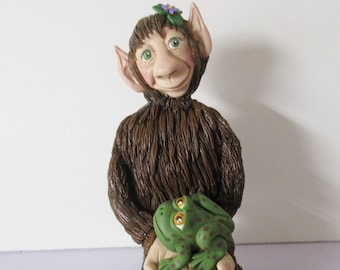 Troll figurine sitting with a pair of frogs. Polymer clay sculpture