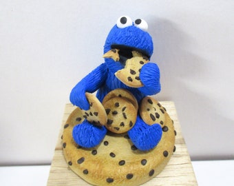 Cookie monster chomping on cookies figurine