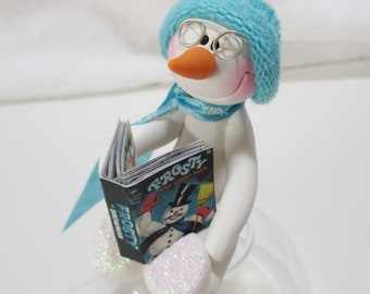 Snowman ornament reading his favorite story book