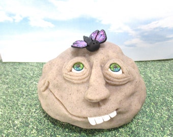 Rock person with a little purple butterfly garden decoration