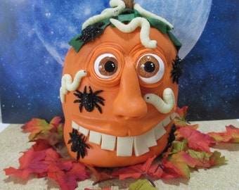 Pumpkin guy with glow in the dark creepy worms and spiders table top decoration