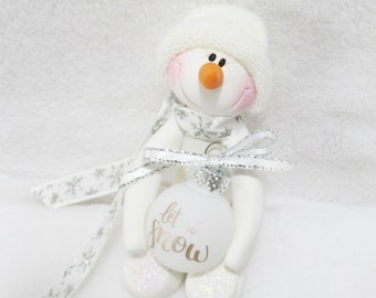 Snowman ornament with a frosty white Let it snow ornament