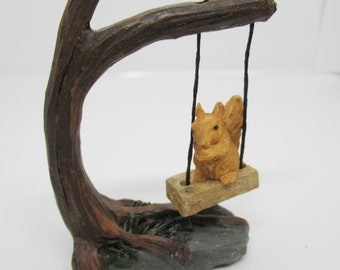 Miniature Squirrel on a tree swing