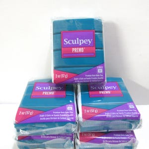 May include: Four packages of teal blue Sculpey Premo oven-bake clay, each package is 2 ounces (57 grams).