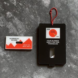 May include: Two black and white motivational cards with red accents. The first card says "Working Hard" and has a red mountain range graphic. The second card says "Your Blorbos Won't Pay For Themselves" and has a pie chart graphic with the words "Blorbo Expenses" and "Rent".
