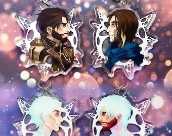 May include: Four acrylic keychains featuring different characters. Each keychain has a white, lacy design around the character's portrait. The characters are all male and have different hair colors and styles.