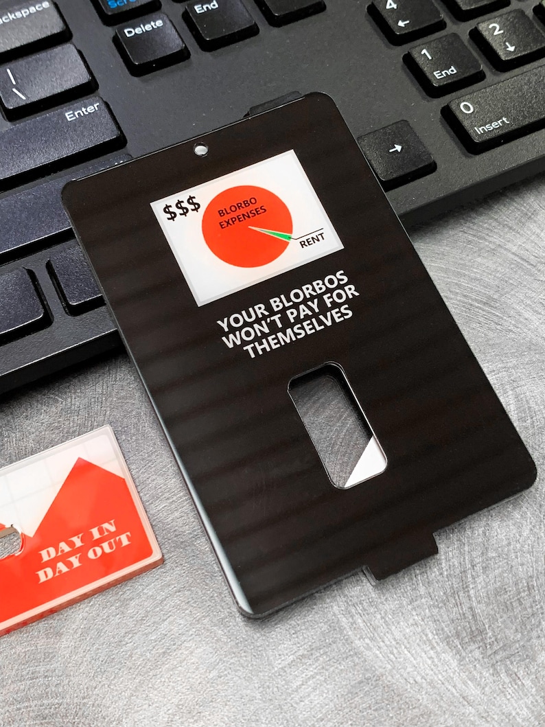 May include: Black card with a white circle graph showing expenses and rent. The text on the card reads "$$$ BLORBO EXPENSES RENT YOUR BLORBOS WON'T PAY FOR THEMSELVES".