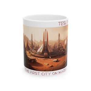 May include: White ceramic mug with a colorful illustration of a futuristic city on Mars. The text "TESLA" and "THE FIRST CITY ON MARS" is printed on the mug.