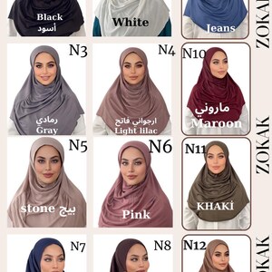 May include: Twelve different colors of jersey knit hijab head scarves. The colors are black, white, jeans, gray, light lilac, stone, pink, khaki, navy blue, brown, and beige. The scarves are arranged in a grid with the color name and number written below each scarf.