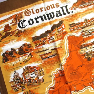 May include: A vintage-style map of Cornwall, England, featuring illustrations of landmarks and towns. The map is in shades of orange, brown, and tan, with the words "Glorious Cornwall" at the top. The map includes the names of towns and points of interest.