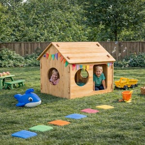 May include: A wooden playhouse with two children inside, decorated with colorful flags. A blue whale-shaped toy, a green picnic table, and a yellow dump truck are on the grass. Stepping stones lead to the playhouse.