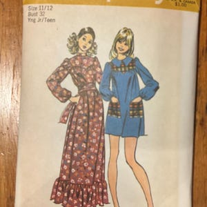 May include: Vintage Simplicity sewing pattern 9778. The pattern features illustrations of two dresses, one long and floral, the other short and blue. The pattern includes sizing information for bust 32 and sizes 11/12, with the text "Yng Jr/Teen".
