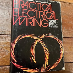 May include: The cover of a book titled "Practical Electrical Wiring" by Herbert P. Richter and W. Creighton Schwan. The book cover is black with red and yellow electrical wiring designs. The book is based on the 1981 National Electrical Code, ANSI/NFPA 70.