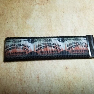 Bloody Rusty Ouija Board Keychain Black Webbing Ribbon Wristlet Key Ring Zipper Pull Bag Tag