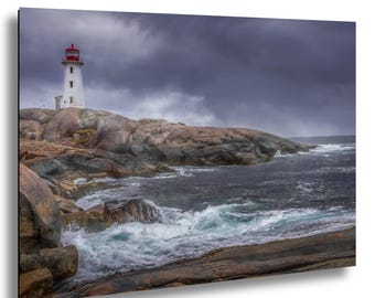 May include: A scenic print of a lighthouse on a rocky coastline under a stormy sky. The white lighthouse with a red top stands on a rocky outcrop, with waves crashing against the rocks. The sky is filled with dark, ominous clouds.