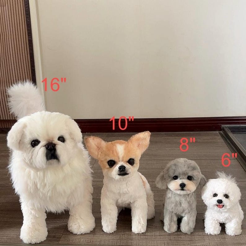 May include: Four plush dog toys in varying sizes. From left to right: a white 16-inch dog, a tan and white 10-inch dog, a gray 8-inch dog, and a white 6-inch dog. Each plush toy features realistic facial details and soft, textured fur.