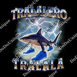 May include: Black graphic tee featuring a shark wearing blue sneakers, with the text "TRALALERO TRALALA" in a gold and blue font. Lightning bolts and a cloudy background complete the design.