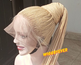 May include: A blonde braided wig with a ponytail. The wig is made with a lace front and is styled in a high ponytail. The wig is on a mannequin head.
