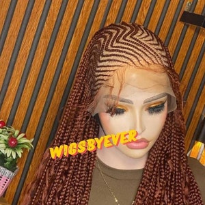 May include: A brown braided wig with a zig-zag pattern on the top. The wig is on a mannequin head and has a lace front. The text "WIGSBYEVER" is visible on the image.