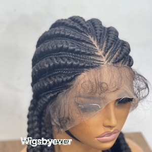 May include: A black braided wig with a lace front. The wig features thick, neatly arranged braids and a natural-looking hairline. The text "Wigsbyever" is visible on the lower left side of the image.