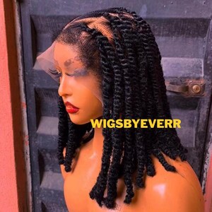 May include: A black twist braid wig on a mannequin head. The wig features a lace front and is styled with individual twists. The text "WIGSBYEVERR" is displayed in yellow letters.