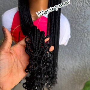 May include: Black braided wig with curly ends. The wig features long, individual braids and a natural-looking hairline. The text "Wigsbyever" is visible in the image.