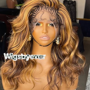 May include: A long, wavy wig with a blend of brown and golden blonde highlights. The wig features a lace front and a braided section at the hairline. The text "Wigsbyever" is visible on the image.