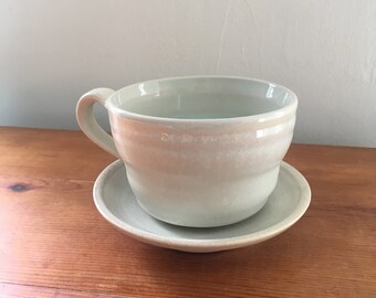 White cup & saucer-oyster white glaze with blue interior.