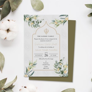 May include: A light blue and white invitation card with a floral design and a gold border. The text on the card reads "THE SANDHU FAMILY Request the pleasure of your company for the auspicious occasion of Sukhmani Sahib Panth To celebrate the 1st birthday of Aman Singh Sandhu AUG SATURDAY 26 AT 10AM followed by Guru Ka Langar at Gurdwara 1 Abcdef Close London AB12 3CD"
