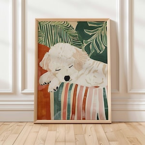 May include: A framed art print featuring a sleeping white dog with closed eyes. The dog rests on a striped surface with green, pink, and orange stripes. Green tropical leaves are in the background. The frame is made of light-colored wood.