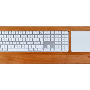 May include: A wooden keyboard and mouse pad set featuring a white keyboard and a white mouse pad. The set is crafted from cherry wood.