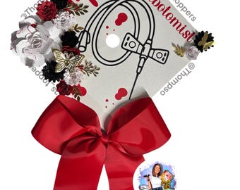 Phlebotomist Graduation Cap Topper: Glitter cardstock base, blood spatter design with butterfly needle, flowers and bow