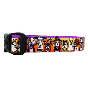 May include: A purple, orange, and green dog collar with a black buckle. The collar features a repeating pattern of dogs dressed in Halloween costumes.