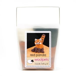 May include: A needle felting kit to make a red panda. The kit includes wool fibres in various colours, a needle, and instructions. The kit is packaged in a clear plastic container with a label that says "red panda woolpets needle felting kit".