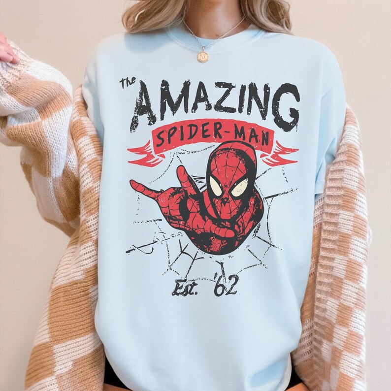 May include: A white ceramic mug with a black handle and the text "But First, Coffee" in a black, bold font. The mug is on a white surface. The mug is approximately 10 cm tall.