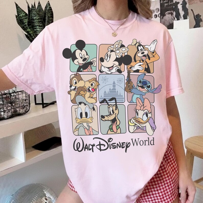 May include: A light pink t-shirt featuring a grid of Disney characters including Mickey Mouse, Minnie Mouse, Goofy, Chip and Dale, Stitch, Donald Duck, Pluto, and Daisy Duck. The words "Walt Disney World" are printed in black script below the grid.