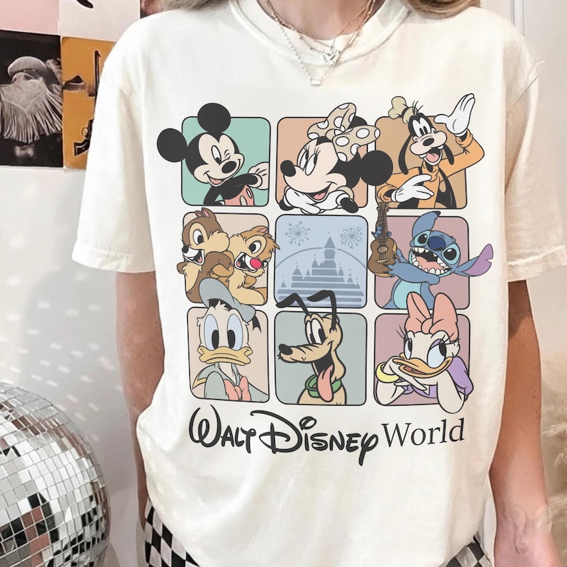 May include: Cream-colored t-shirt featuring a grid of Disney characters including Mickey Mouse, Minnie Mouse, Goofy, Chip and Dale, Donald Duck, Pluto, Stitch, and Daisy Duck. The words "Walt Disney World" are printed below the grid in a script font.
