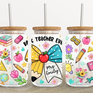 May include: Clear glass can-shaped tumbler with a wooden lid and a silver straw. The tumbler is decorated with colorful teacher-themed illustrations, including pencils, apples, and the text "Best Teacher Ever".