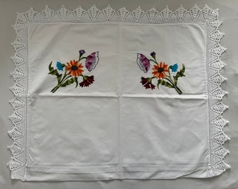 Hand-embroidered cushion cover with crocheted lace border (bouquet of flowers)