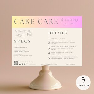 May include: A cream-colored cake care and cutting guide with a gradient pink and yellow header. The guide includes details on storage, allergens, and flavor. The guide is displayed on a white pedestal.