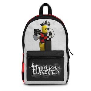May include: A black backpack with a white and red checkered pattern on the sides. The front features a cartoon character with a crown and a box. The word "FORSAKEN" is written in white on the front pocket.