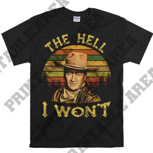 May include: Black t-shirt featuring a vintage-style graphic of a cowboy with the text "The Hell I Won't".