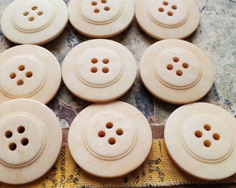 Nine (9) Matching Bone Buttons. Measure approx 1 1/8" and are four hole. Great for Handknit sweaters or Jewelry crafts.