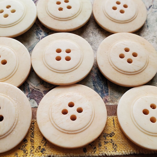 Nine (9) Matching Bone Buttons. Measure approx 1 1/8" and are four hole. Great for Handknit sweaters or Jewelry crafts.