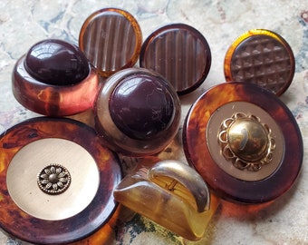 Eight (8) Bakelite or Casein, Vintage or Antique, Buttons. Collectible. Measure 1 1/2" and under. Metal loop shanks.