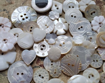 Forty Five (45), Carved Shell Buttons. Vintage. Measure approx 1 1/8" to 1/2". Mostly Small. Time Worn.